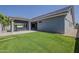 Exterior view of the home featuring a backyard with manicured lawn and hot tub at 20452 E Appaloosa Dr, Queen Creek, AZ 85142
