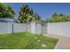 Backyard featuring a shed, privacy wall, and manicured lawn at 20452 E Appaloosa Dr, Queen Creek, AZ 85142