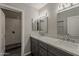 Beautiful bathroom featuring a double sink vanity with marble countertop and modern lighting fixtures at 20452 E Appaloosa Dr, Queen Creek, AZ 85142