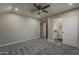 Spacious bedroom with plush carpeting, ceiling fan, and walk-in closet at 20452 E Appaloosa Dr, Queen Creek, AZ 85142
