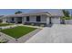 Modern exterior with gray paint, black accent, dark roof, driveway, well maintained lawn at 20452 E Appaloosa Dr, Queen Creek, AZ 85142