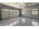 Well-lit three car garage with windows, ready for parking and storage at 20452 E Appaloosa Dr, Queen Creek, AZ 85142