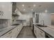 This modern kitchen features stainless steel appliances, white cabinets, and a large island for entertaining at 20452 E Appaloosa Dr, Queen Creek, AZ 85142