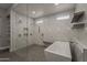 This main bathroom features a glass shower enclosure, soaking tub, and white marble walls at 20452 E Appaloosa Dr, Queen Creek, AZ 85142