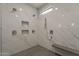 Close-up of a large walk-in shower with rainfall shower head and marble walls at 20452 E Appaloosa Dr, Queen Creek, AZ 85142