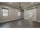 Large main bedroom showcasing wood-style floors, neutral walls, and sliding barn door to ensuite bath at 20452 E Appaloosa Dr, Queen Creek, AZ 85142
