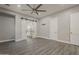 An open main bedroom showcases the ensuite bathroom, wood-style floors, and neutral walls at 20452 E Appaloosa Dr, Queen Creek, AZ 85142