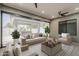 Modern sunroom with comfortable seating, stylish rug, and large windows for natural light and views of the outdoor space at 20452 E Appaloosa Dr, Queen Creek, AZ 85142