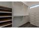 Walk-in closet features built-in organizers, shelving, drawers, and a window to provide natural light at 20452 E Appaloosa Dr, Queen Creek, AZ 85142