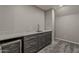 Stylish wet bar area with modern cabinets, marble countertop, and beverage cooler at 20452 E Appaloosa Dr, Queen Creek, AZ 85142
