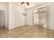 Spacious bedroom featuring tile floors, neutral walls, a ceiling fan, and slider doors for backyard access at 2063 S Edgewater --, Mesa, AZ 85209