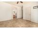 Bright bedroom with tile floors, neutral walls, and a door leading to an ensuite bathroom at 2063 S Edgewater --, Mesa, AZ 85209