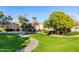 Well-maintained common area featuring a grassy lawn and sidewalk connecting the community at 2063 S Edgewater --, Mesa, AZ 85209
