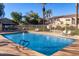 Sparkling community pool with lounge chairs and a secure fence for residents' enjoyment at 2063 S Edgewater --, Mesa, AZ 85209