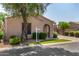 Charming single-story home featuring desert landscaping, an arched entry, and a well-manicured lawn at 2063 S Edgewater --, Mesa, AZ 85209