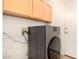 Convenient laundry room with a modern washer, overhead cabinets, and a nearby exit door at 2063 S Edgewater --, Mesa, AZ 85209