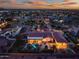 Aerial view of an estate, highlighting the backyard pool, patio, and desert landscaping at twilight at 24695 S 195Th Way, Queen Creek, AZ 85142