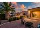 Outdoor area with a fire pit, lush landscaping, and a covered patio in this relaxing backyard at 24695 S 195Th Way, Queen Creek, AZ 85142