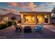 Backyard features a covered patio, gravel landscape, and a fire pit with comfortable seating at 24695 S 195Th Way, Queen Creek, AZ 85142