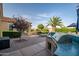 Outdoor living with a built-in barbecue, seating area and lush landscaping, perfect for entertaining at 24695 S 195Th Way, Queen Creek, AZ 85142