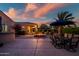 Inviting backyard with a fire pit, patio seating, and beautiful desert landscaping at sunset at 24695 S 195Th Way, Queen Creek, AZ 85142