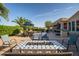 Relaxing backyard retreat with a decorative fire pit, manicured landscaping, and palm trees at 24695 S 195Th Way, Queen Creek, AZ 85142