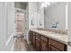 Bathroom with dual sinks, wood cabinets, a large mirror, and access to a separate shower and toilet area at 24695 S 195Th Way, Queen Creek, AZ 85142