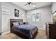 A cozy bedroom featuring a wooden bed frame, neutral walls, and a ceiling fan at 24695 S 195Th Way, Queen Creek, AZ 85142