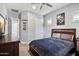 Neutral bedroom with a wood bed frame, gray walls, and a closet door at 24695 S 195Th Way, Queen Creek, AZ 85142