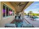 Inviting covered patio with ceiling fans, outdoor seating, and a view of the sparkling pool at 24695 S 195Th Way, Queen Creek, AZ 85142