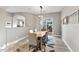 Bright dining room features a wooden table, rug and lots of natural light from the sliding glass door at 24695 S 195Th Way, Queen Creek, AZ 85142