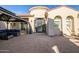 Elegant home featuring an arched entryway, custom front door, and comfortable outdoor seating at 24695 S 195Th Way, Queen Creek, AZ 85142
