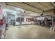 Spacious garage with ample storage, a car lift, and a well-organized workbench area at 24695 S 195Th Way, Queen Creek, AZ 85142