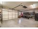 Large garage with high ceilings, a large roll up door, and ample space for parking and projects at 24695 S 195Th Way, Queen Creek, AZ 85142