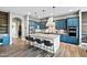 Elegant kitchen with blue cabinets, stainless appliances, granite countertops, and a large island with seating at 24695 S 195Th Way, Queen Creek, AZ 85142
