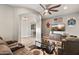 Comfortable living room featuring stylish decor, a ceiling fan and entertainment center for relaxation and enjoyment at 24695 S 195Th Way, Queen Creek, AZ 85142