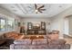Spacious living room with ceiling fan, entertainment center, coffered ceiling and comfortable seating at 24695 S 195Th Way, Queen Creek, AZ 85142