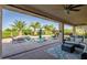 Relaxing covered patio area with comfortable seating, ceiling fans, and views of the pool at 24695 S 195Th Way, Queen Creek, AZ 85142