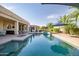 Sparkling pool with rock accents, tropical landscaping, and a covered patio at 24695 S 195Th Way, Queen Creek, AZ 85142