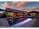 Backyard pool with lounge chairs, patio, and outdoor furniture at dusk at 24695 S 195Th Way, Queen Creek, AZ 85142