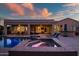 Backyard pool with a spa, covered patio, and lounge chairs at sunset at 24695 S 195Th Way, Queen Creek, AZ 85142
