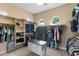 Spacious walk-in closet featuring custom shelving, a built-in safe, and natural light from clerestory windows at 24695 S 195Th Way, Queen Creek, AZ 85142