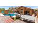 Well-maintained backyard showcasing a pool, patio, hot tub, and landscaping at 25840 W Whyman St, Buckeye, AZ 85326