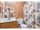 Cozy bathroom featuring a vanity with wooden cabinets and a shower/tub combo at 25840 W Whyman St, Buckeye, AZ 85326