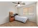 Comfortable bedroom featuring a ceiling fan, natural light and carpet at 25840 W Whyman St, Buckeye, AZ 85326