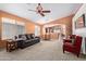 Spacious living room featuring a comfortable sofa, ceiling fan, and lots of natural light at 25840 W Whyman St, Buckeye, AZ 85326