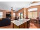 Open-concept living room featuring a large island with sink, wood floors, and high ceilings at 25840 W Whyman St, Buckeye, AZ 85326