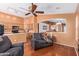 Open-concept living room featuring a fan, and open kitchen with counter seating at 25840 W Whyman St, Buckeye, AZ 85326
