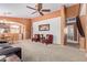 Comfortable living room featuring neutral-colored walls and flooring, accent chairs, and a ceiling fan at 25840 W Whyman St, Buckeye, AZ 85326