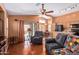 Open-concept living room featuring wood floors, comfortable seating, and open kitchen at 25840 W Whyman St, Buckeye, AZ 85326